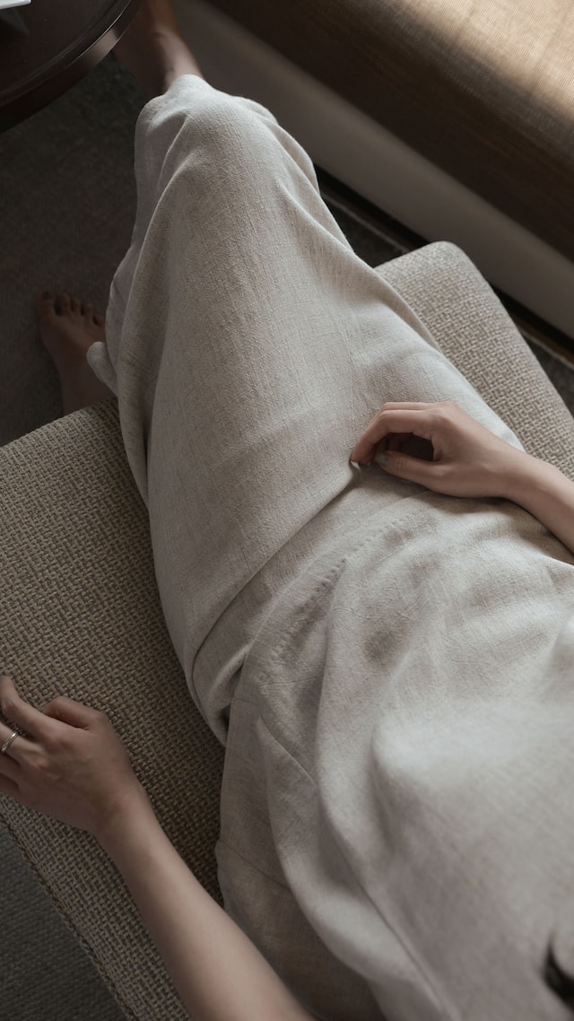 white-linen-dress A woman wears a simple linen dress