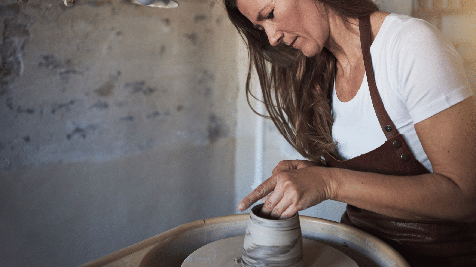 Artisan woman crafts a vase in Florence