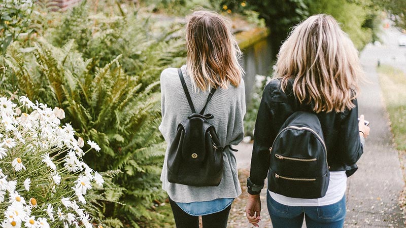 Two women in Florence wearing their black backpacks