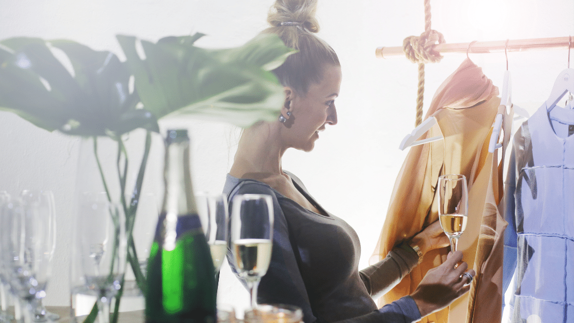 A woman shops and drinks champagne in a luxury shop