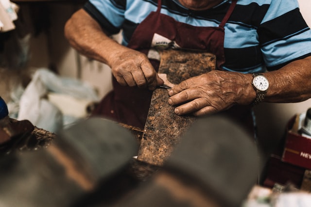 An artisan is working with leather
