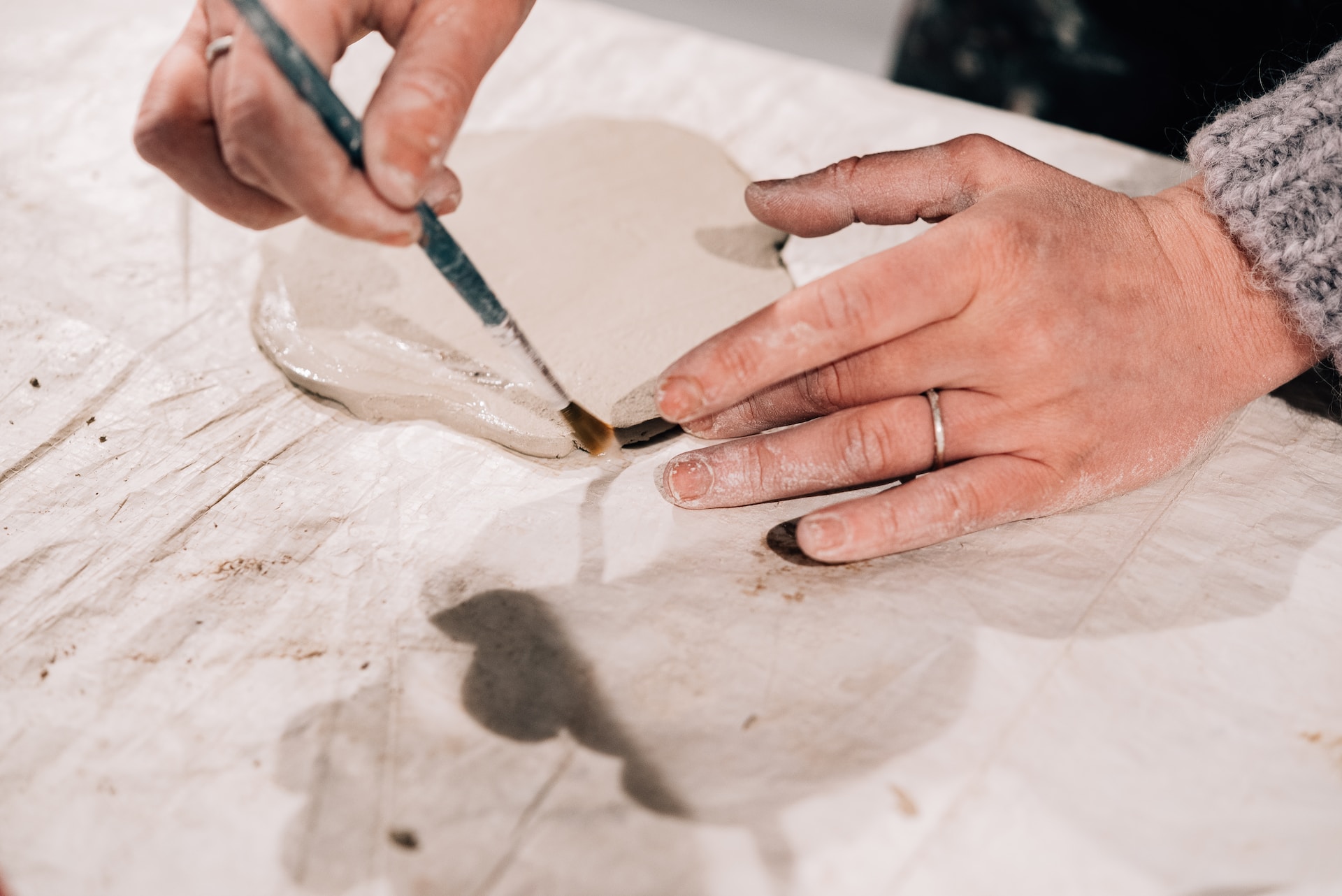 An expert pottery artisan finishing a vase