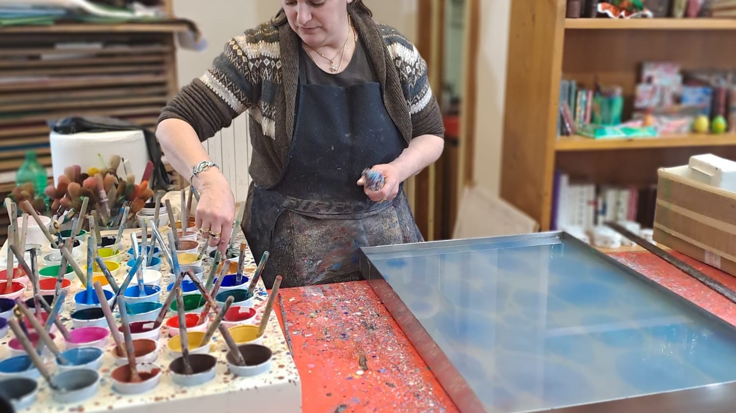 marbled-paper-artisan An artisan is creating some marbled paper in her shop in Florence