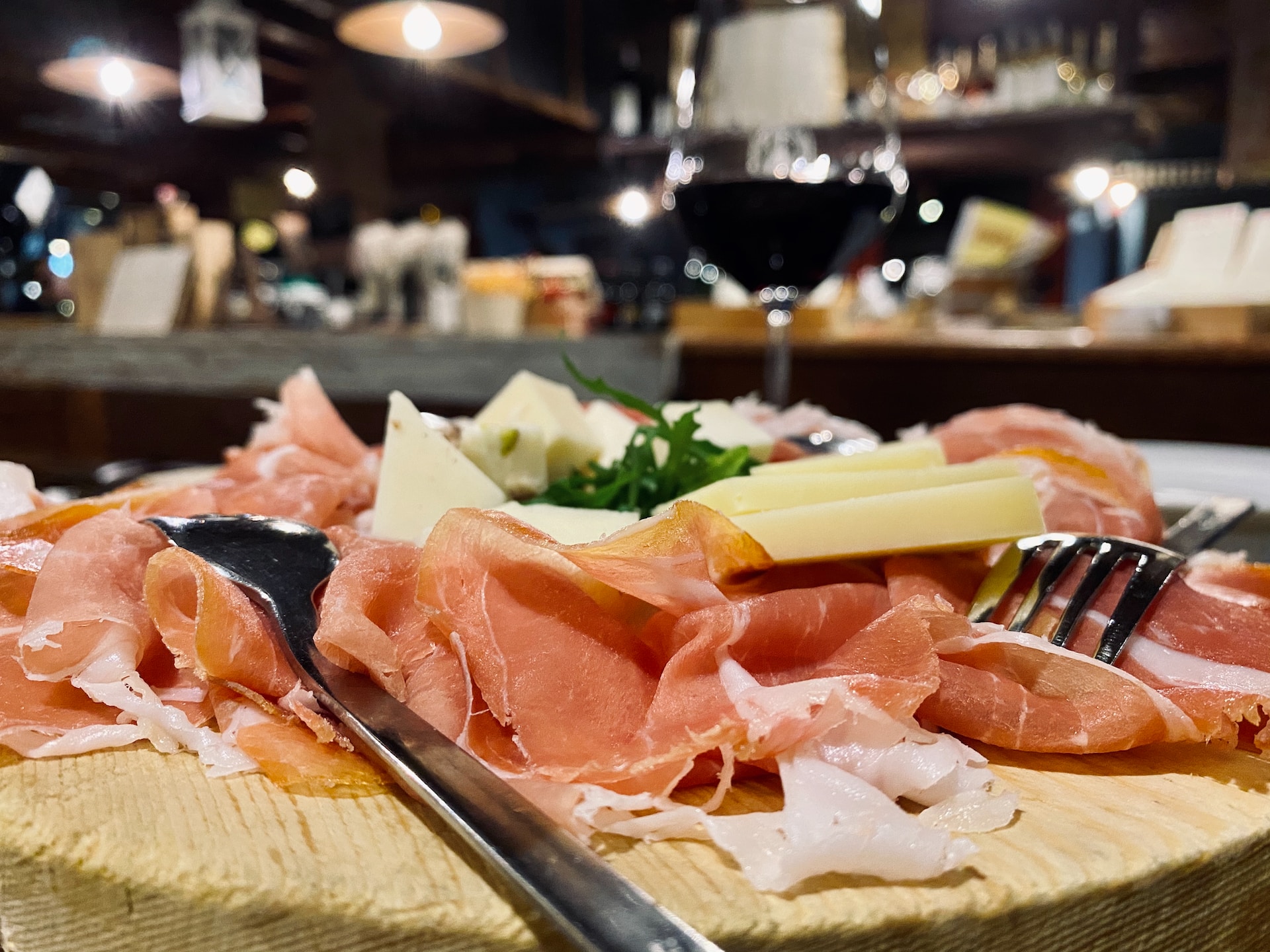 Prosciutto and cheese on a plate ready to be savoured during a food tour in Florence