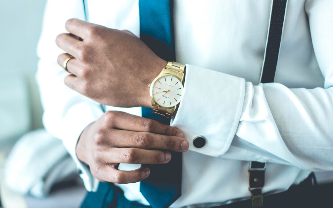 A man is wearing an elegant watch and a shirt