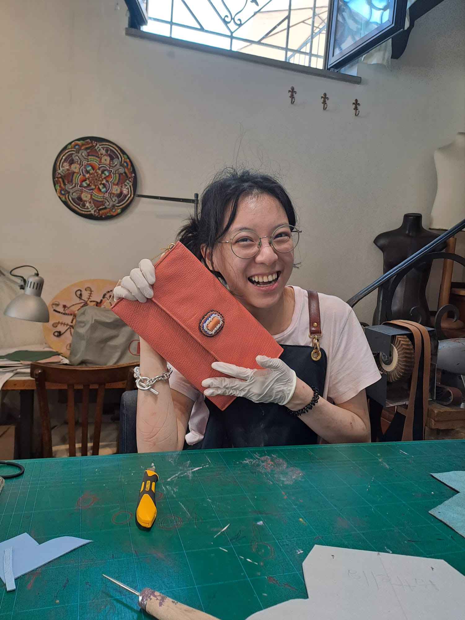 An artisan showcasing her leather work in Florence, Italy