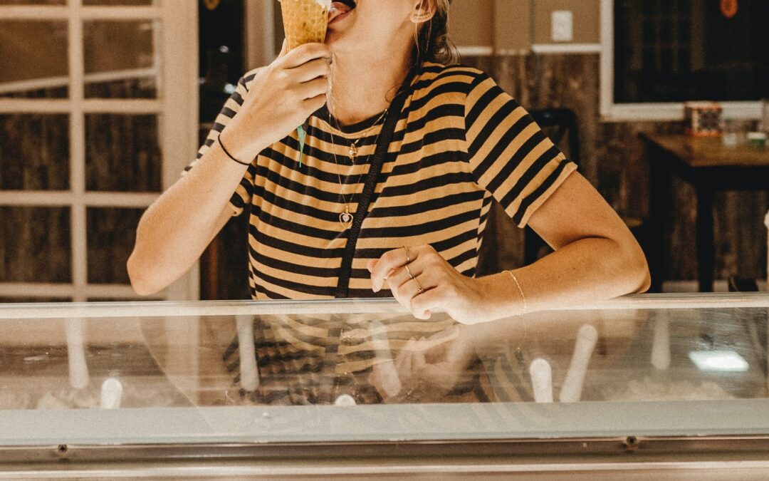 A young woman eating gelato in Florence, Italy during a food tour