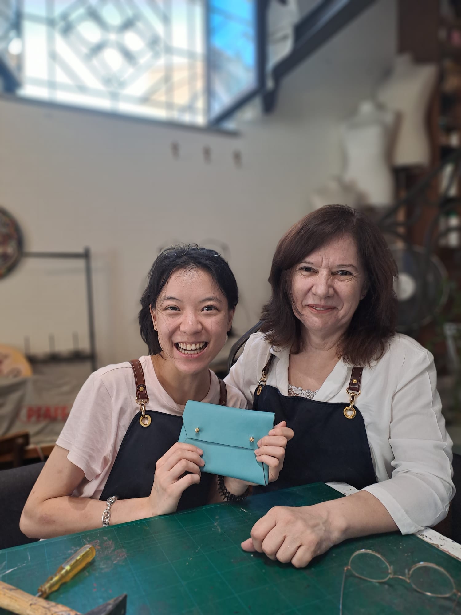 Happy student with her teacher after the leather workshop in Florence