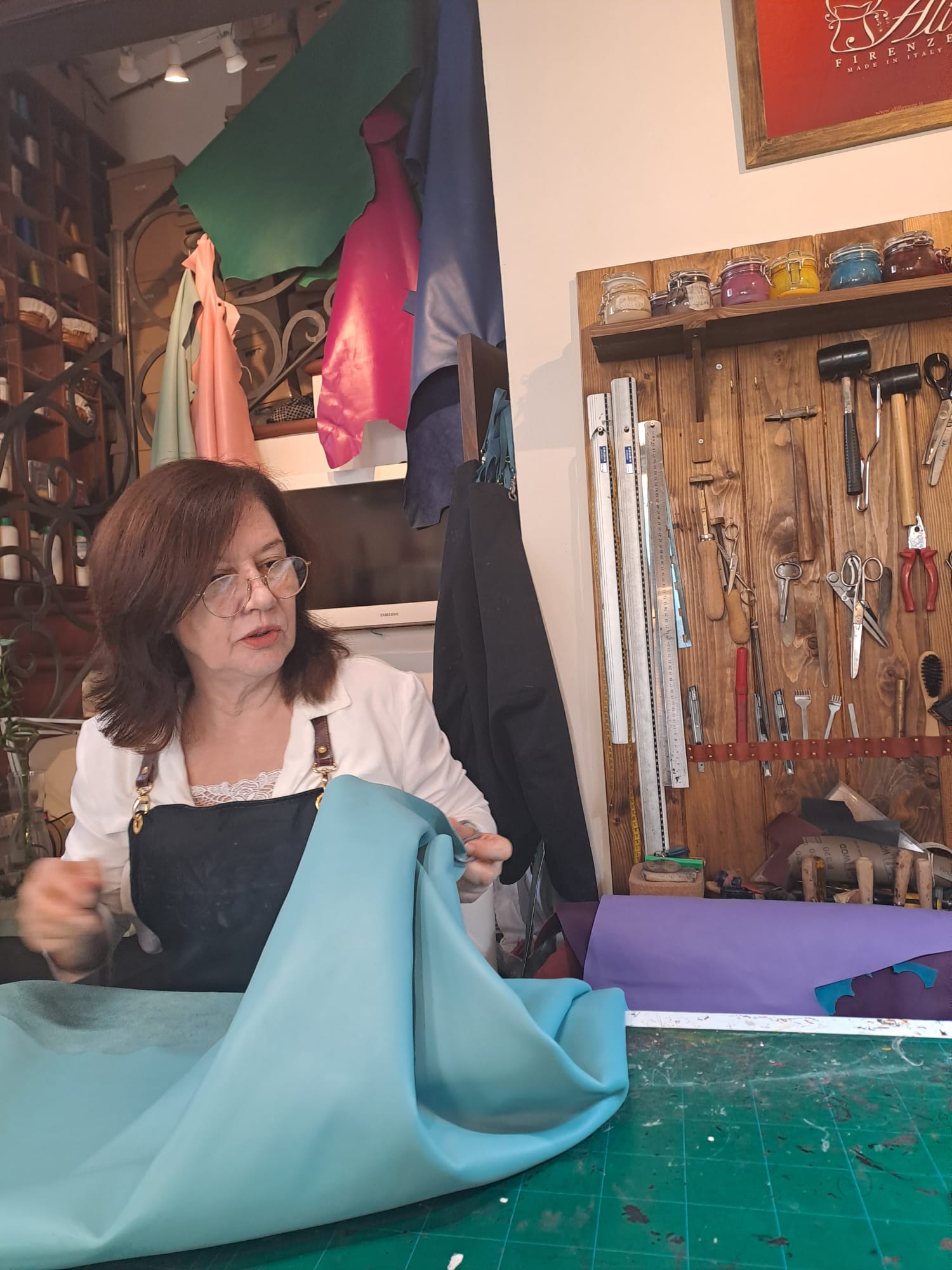 Leather master showing her craft during a workshop in Florence, Italy