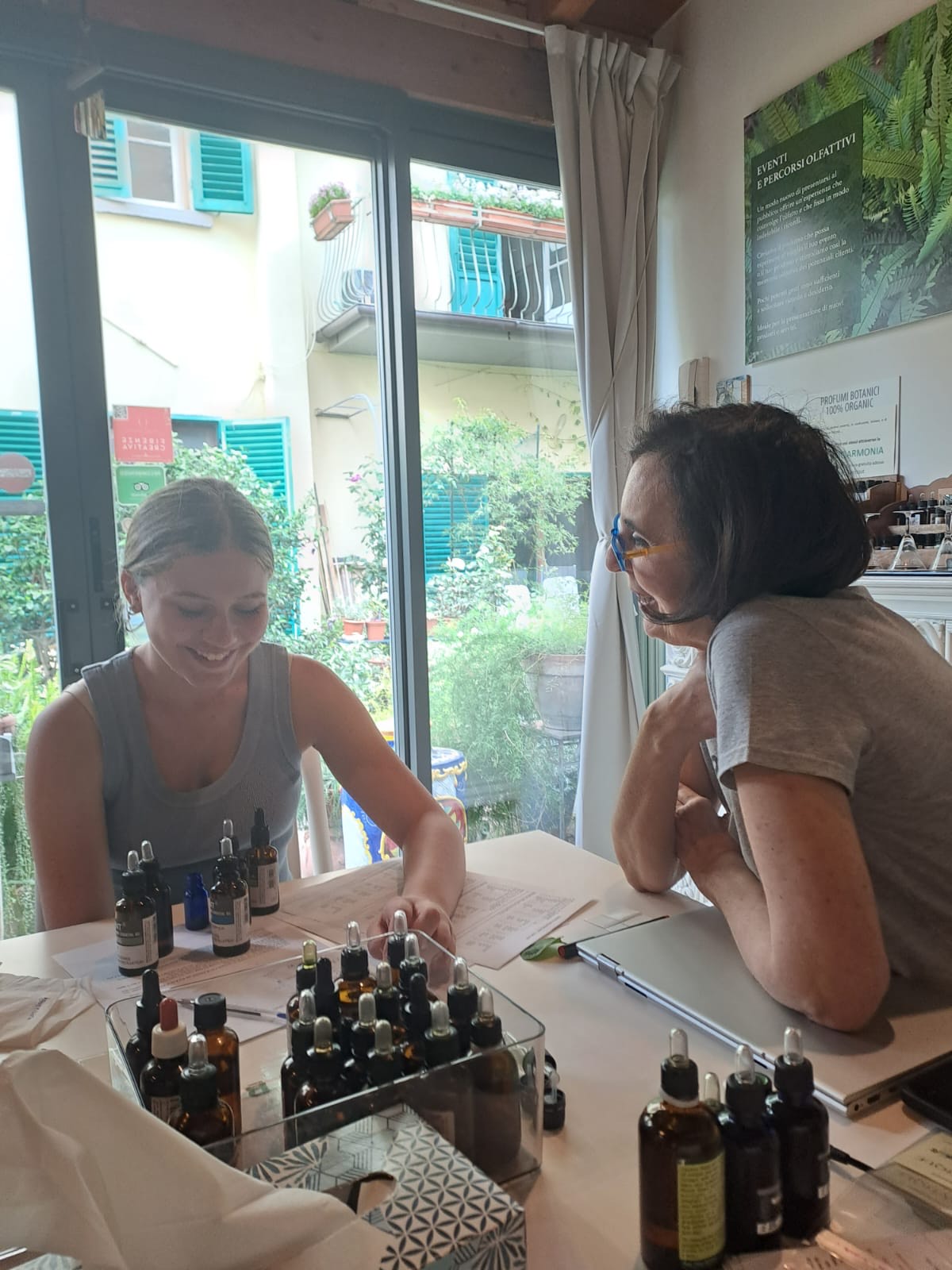 Student is happy to talk with a perfume master in her atelier in Florence